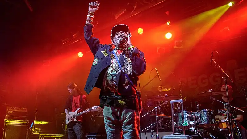Image thanks to © pitpony.photography - www.pitpony.photography.de  lee scratch perry performing live on stage with band at reggae concert. 